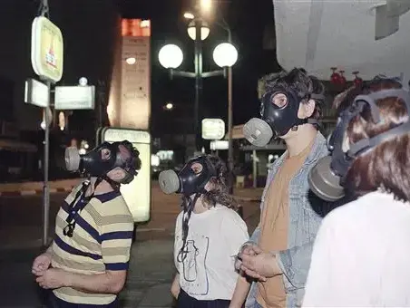 אזרחים בתל אביב עם מסיכות האב"כ על פניהם, 1991 (AP , הרברט פרופר) אזרחים בתל אביב עם מסיכות האב"כ על פניהם, 1991 (AP , הרברט פרופר)