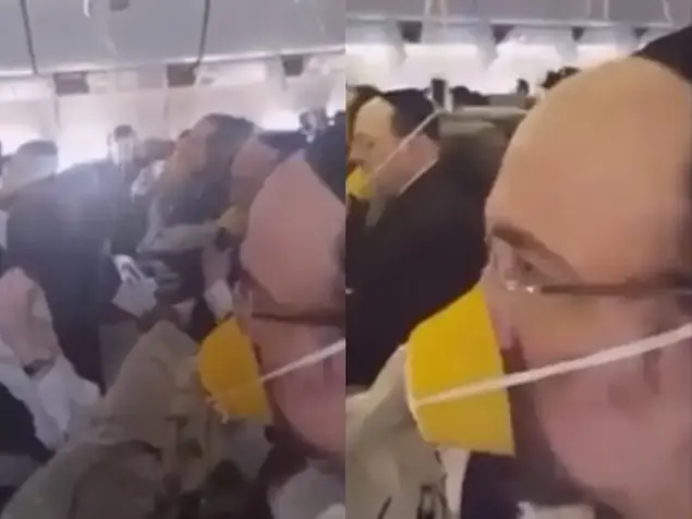 נוסעים דתיים חובשים מסכות חמצן בטיסה (צילום מסך , youtube)