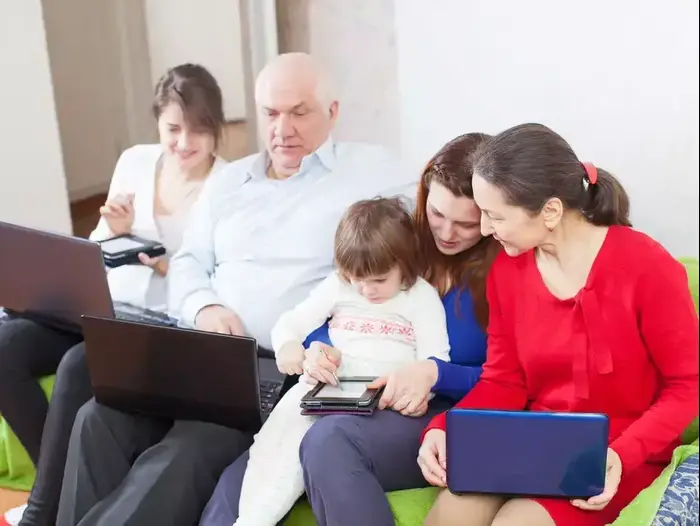 משפחה עם מחשבים בסלון (ShutterStock) משפחה עם מחשבים בסלון (ShutterStock)