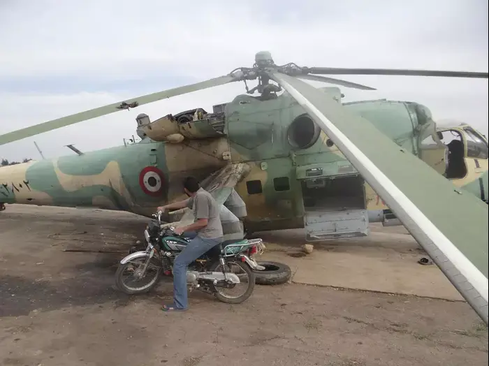 מורד סורי ליד מסוק Mi-24 של הצבא בבסיס תפנתאז בצפון-מערב סוריה. מאי 2013 (רויטרס) מורד סורי ליד מסוק Mi-24 של הצבא בבסיס תפנתאז בצפון-מערב סוריה. מאי 2013 (רויטרס)