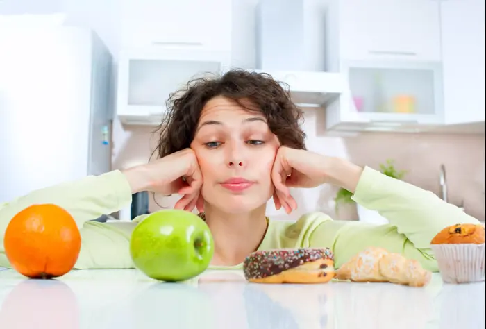 אישה מסתכלת על אוכל (ShutterStock)