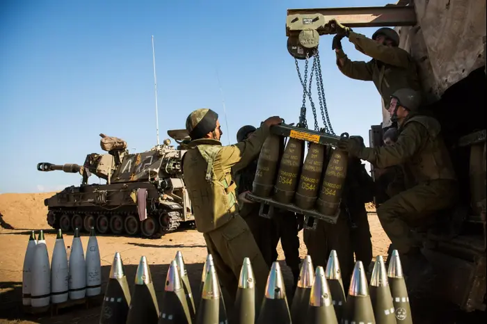 חיילים מארגנים פגזים ליד תותח בגבול רצועת עזה במבצע צוק איתן יולי 2014 (GettyImages) חיילים מארגנים פגזים ליד תותח בגבול רצועת עזה במבצע צוק איתן יולי 2014 (GettyImages)