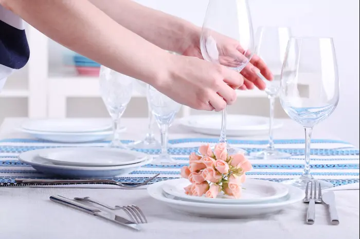 ידי אישה עורכת שולחן חג (ShutterStock) ידי אישה עורכת שולחן חג (ShutterStock)
