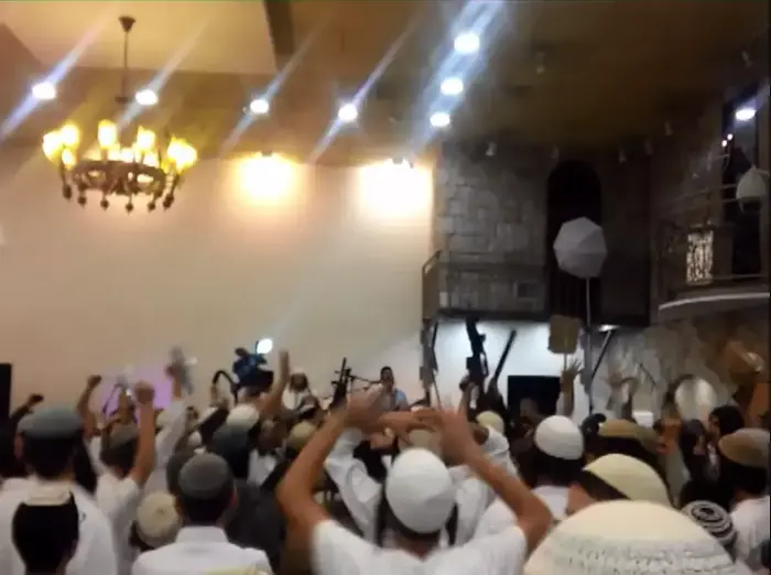 פעילי ימין חוגגים בחתונה ומניפים נשקים ונועצים סכין בתמונת התינוק עלי דוואבשה. דצמבר 2015 (צילום מסך , חדשות 10) פעילי ימין חוגגים בחתונה ומניפים נשקים ונועצים סכין בתמונת התינוק עלי דוואבשה. דצמבר 2015 (צילום מסך , חדשות 10)