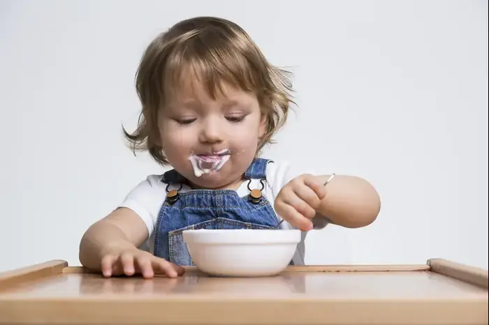 פעוטה אוכלת יוגורט (ShutterStock) פעוטה אוכלת יוגורט (ShutterStock)