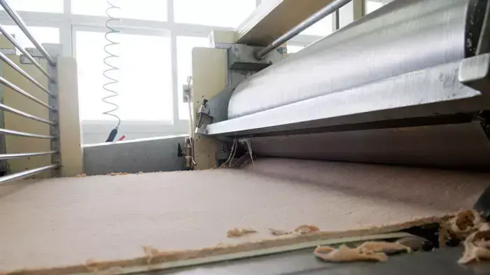 תהליך הכנת מצות: חיתוך קצוות הבצק והכנה לרידוד נוסף תהליך הכנת מצות: חיתוך קצוות הבצק והכנה לרידוד נוסף