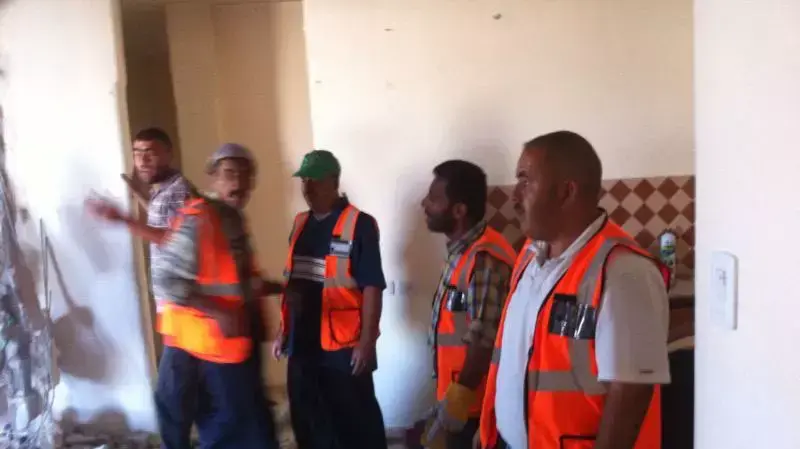 עובדי עיריית חברון מנקים את ביתו עאמר קוואסמה, יולי 2014 עובדי עיריית חברון מנקים את ביתו עאמר קוואסמה, יולי 2014