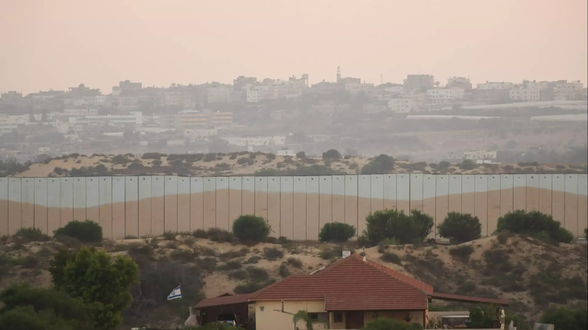 בתים במושב נתיב העשרה על רקע רצועת עזה, מבצע "צוק איתן", יולי 2014 בתים במושב נתיב העשרה על רקע רצועת עזה, מבצע "צוק איתן", יולי 2014