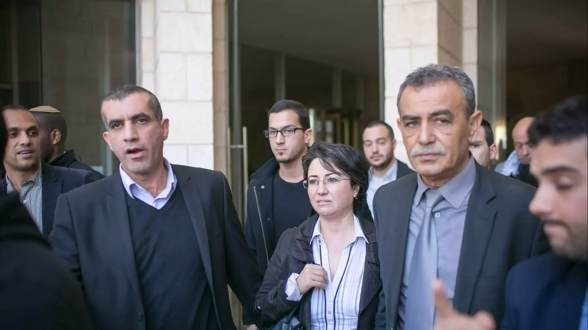 חנין זועבי מלווה בחברי מפלגתה יוצאת מהדיון בהחלטת ועדת הבחירות המרכזית לכנסת לפסול את מועמדותה, פברואר 2015