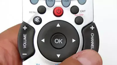 איש מחזיק שלט טלוויזיה וידאו לחצנים