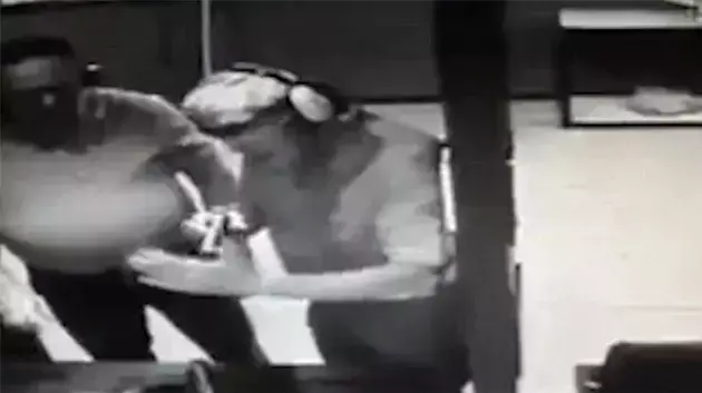 אדם בודק אקדח במטווח