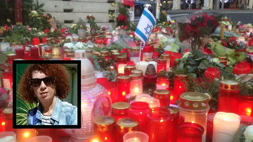 דליה אליקים הישראלית שנרצחה בפיגוע מפיגוע הדריסה בשוק חג המולד בברלין על רקע נרות זיכרון שהוצבו במקום