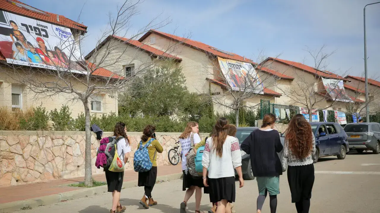 תלמידות עוברות ליד הבתים שצפויים להתפנות בעפרה מחר, 27 בפברואר 2017 תלמידות עוברות ליד הבתים שצפויים להתפנות בעפרה מחר, 27 בפברואר 2017