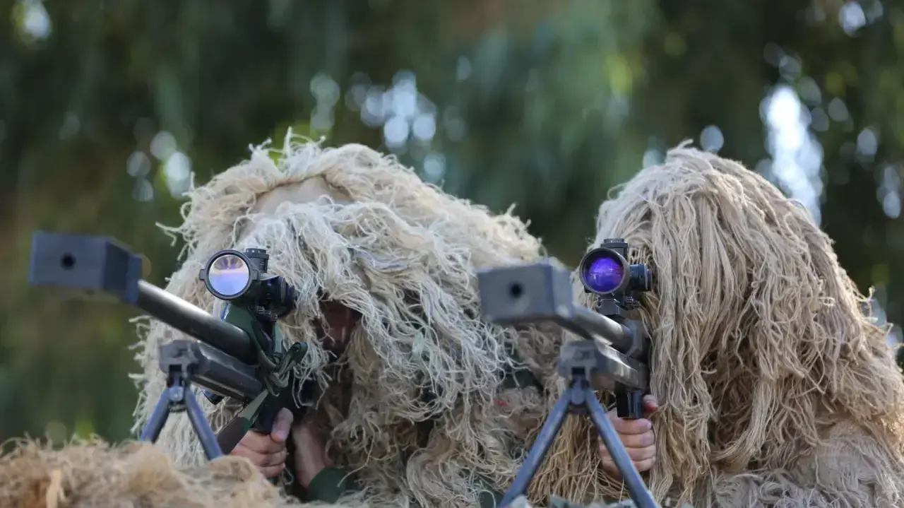 חיילים בהסוואה בתערוכה הצבאית של גדודי הקסאם בחאן יונס, 15 בדצמבר 2018 חיילים בהסוואה בתערוכה הצבאית של גדודי הקסאם בחאן יונס, 15 בדצמבר 2018