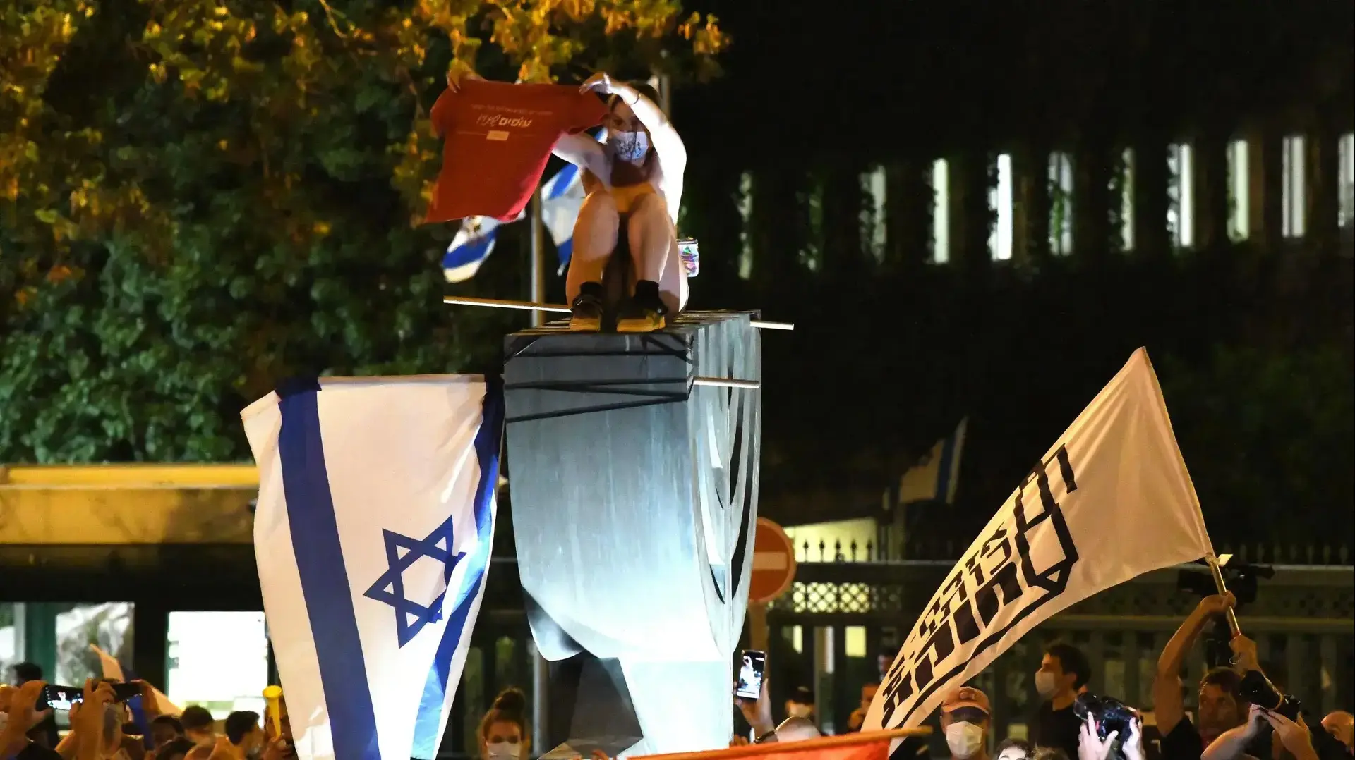 המחאות בירושלים: מפגינה חשופת חזה תועדה על סמל המנורה מול הכנסת, 22 ביולי 2020 המחאות בירושלים: מפגינה חשופת חזה תועדה על סמל המנורה מול הכנסת, 22 ביולי 2020