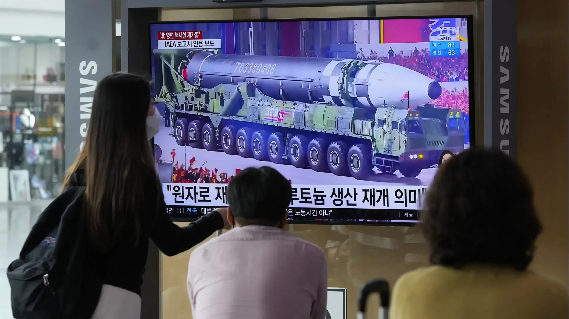 People watch a TV screen showing a file image of a North Korean missile in a military parade during a news program at the Seoul Railway Station in Seoul, South Korea, Monday, Aug. 30, 2021. North Korea appears to have restarted the operation of its main nuclear reactor used to produce weapons fuels, the U.N. atomic agency said, as the North openly threatens to enlarge its nuclear arsenal amid long-dormant nuclear diplomacy with the United States. Korean letters read: "The reactor produces pluto People watch a TV screen showing a file image of a North Korean missile in a military parade during a news program at the Seoul Railway Station in Seoul, South Korea, Monday, Aug. 30, 2021. North Korea appears to have restarted the operation of its main nuclear reactor used to produce weapons fuels, the U.N. atomic agency said, as the North openly threatens to enlarge its nuclear arsenal amid long-dormant nuclear diplomacy with the United States. Korean letters read: "The reactor produces pluto