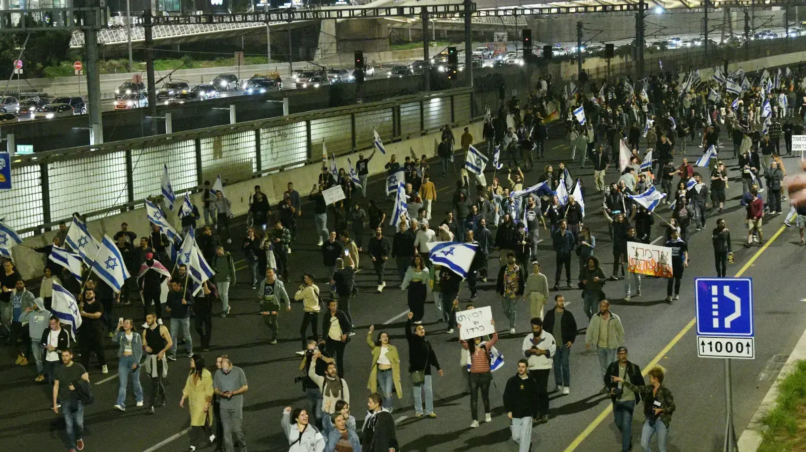 מפגינים נגד המהפכה המשפטית יורדים לכביש נתיבי איילון, תל אביב, 4 במרץ 2023 מפגינים נגד המהפכה המשפטית יורדים לכביש נתיבי איילון, תל אביב, 4 במרץ 2023