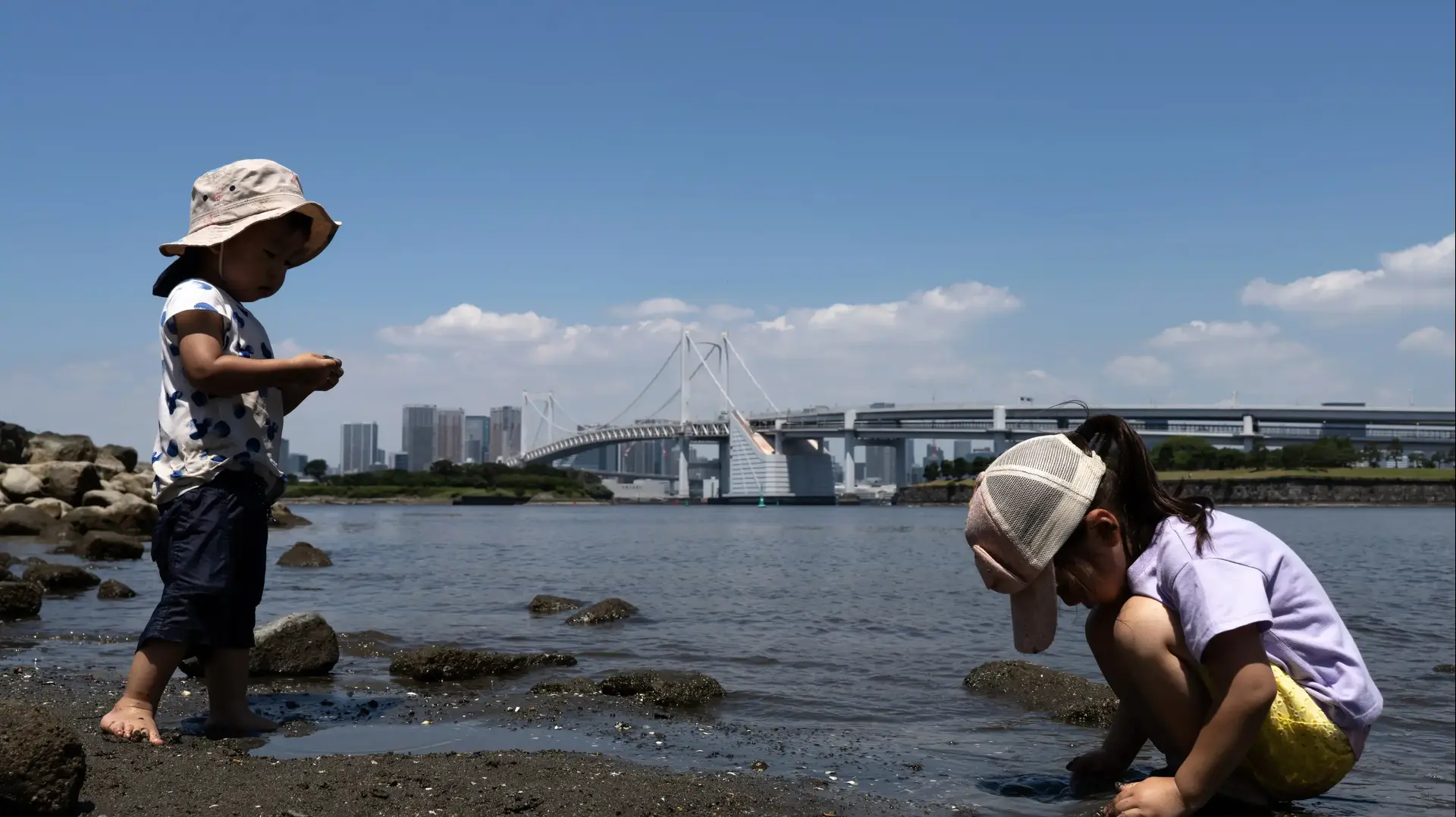 TOKYO, JAPAN - JULY 17: Children play in front of the Rainbow Bridge at Odaiba Beach on July 17, 2023 in Tokyo, Japan. The government issued heatstroke alerts for 32 of the country's 47 prefectures including Tokyo as temperatures soared to 39 degrees Celsius in some of the areas. (Photo by Tomohiro Ohsumi/Getty Images)
TOKYO, JAPAN - JULY 17: Children play in front of the Rainbow Bridge at Odaiba Beach on July 17, 2023 in Tokyo, Japan. The government issued heatstroke alerts for 32 of the country's 47 prefectures including Tokyo as temperatures soared to 39 degrees Celsius in some of the areas. (Photo by Tomohiro Ohsumi/Getty Images)
