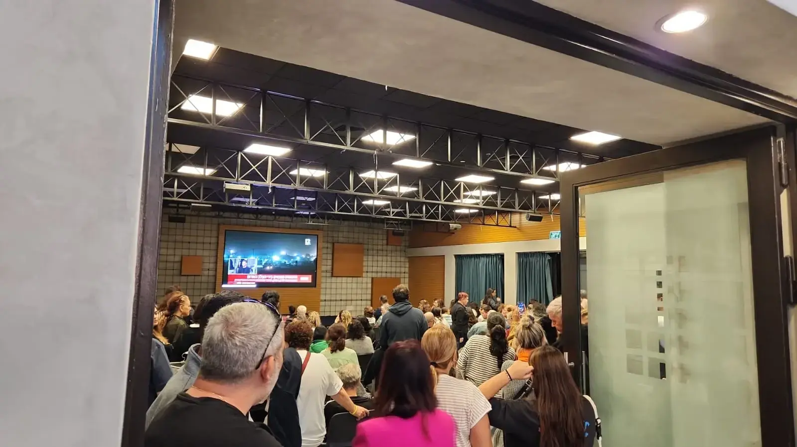 תושבי קיבוץ כפר עזה יושבים יחד באולם במלון שפיים, בו שוהות מרבית משפחות הקיבוץ כבר שבעה שבועות. 26 בנובמבר 2023 תושבי קיבוץ כפר עזה יושבים יחד באולם במלון שפיים, בו שוהות מרבית משפחות הקיבוץ כבר שבעה שבועות. 26 בנובמבר 2023
