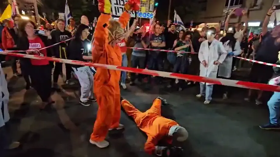מיצג מפגינים בדמויותיהם של בנימין ושרה נתניהו, הפגנה ברחוב בגין תל אביב, 26 באפריל 2025 מיצג מפגינים בדמויותיהם של בנימין ושרה נתניהו, הפגנה ברחוב בגין תל אביב, 26 באפריל 2025