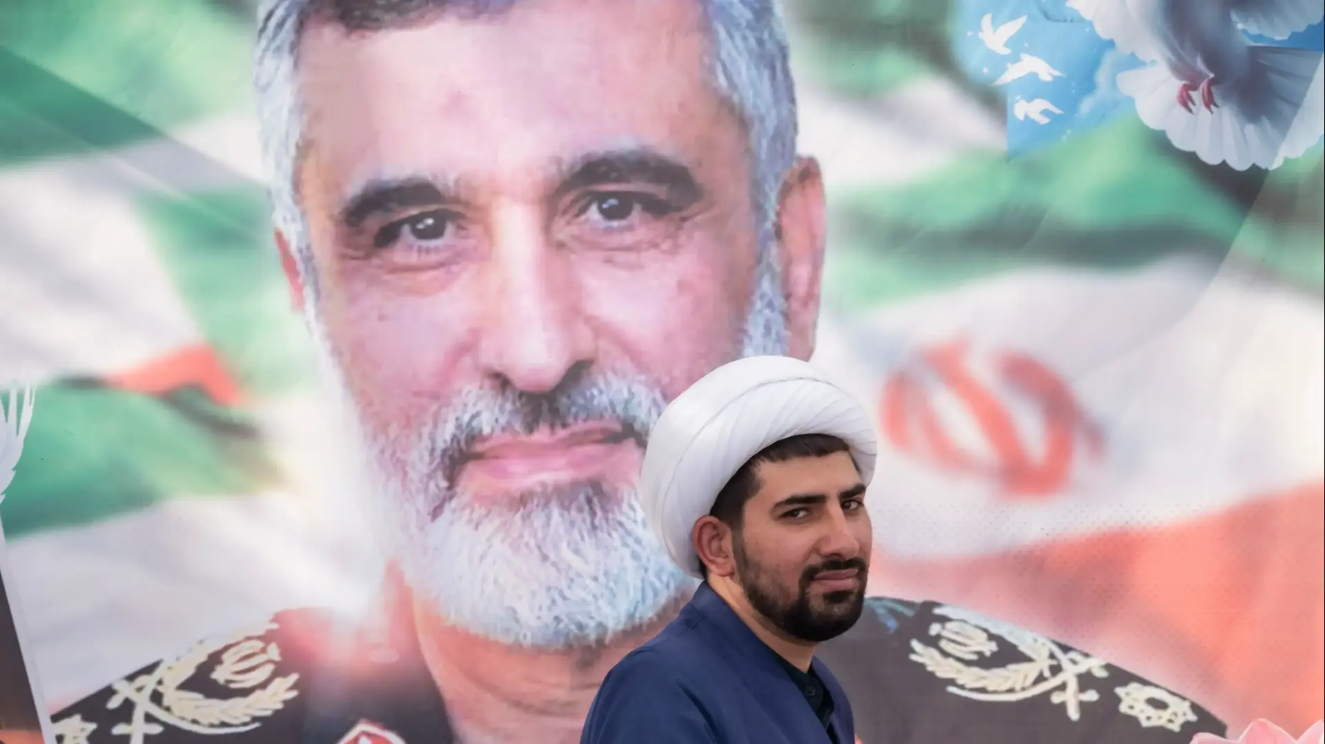 An Iranian cleric stands in front of a portrait of the former commander of the IRGC Aerospace Forces, Brigadier General Amir Ali Hajizadeh, who is killed in Israeli attacks, during a religious rally called the 10km party to condemn Israeli attacks on Iran, in downtown Tehran, Iran, on June 14, 2025. (Photo by Morteza Nikoubazl/NurPhoto)NO USE FRANCE
An Iranian cleric stands in front of a portrait of the former commander of the IRGC Aerospace Forces, Brigadier General Amir Ali Hajizadeh, who is killed in Israeli attacks, during a religious rally called the 10km party to condemn Israeli attacks on Iran, in downtown Tehran, Iran, on June 14, 2025. (Photo by Morteza Nikoubazl/NurPhoto)NO USE FRANCE