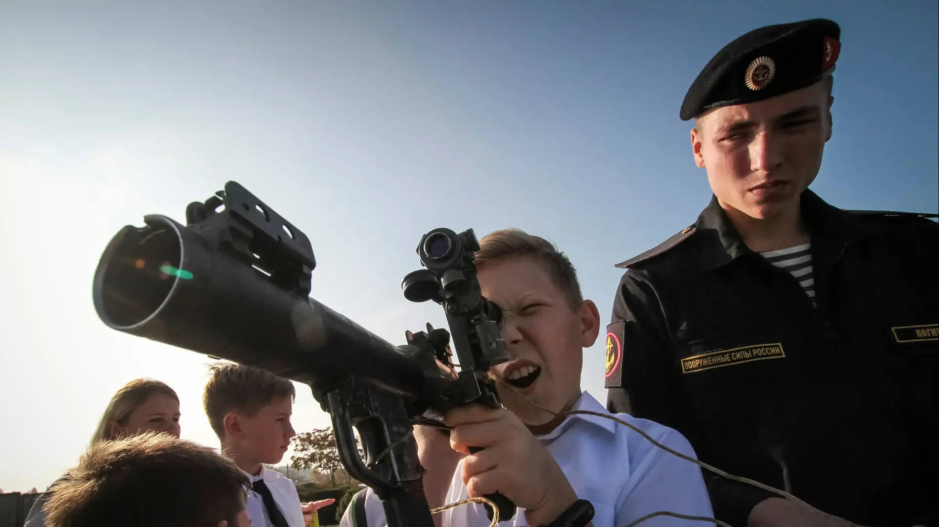 A boy holds a grenade launcher at a military hardware exhibition during a swear-in ceremony for new recruits of the Russian military-patriotic club "Yunarmia" (Young army) in the Black Sea port of Sevastopol, Crimea, October 25, 2019