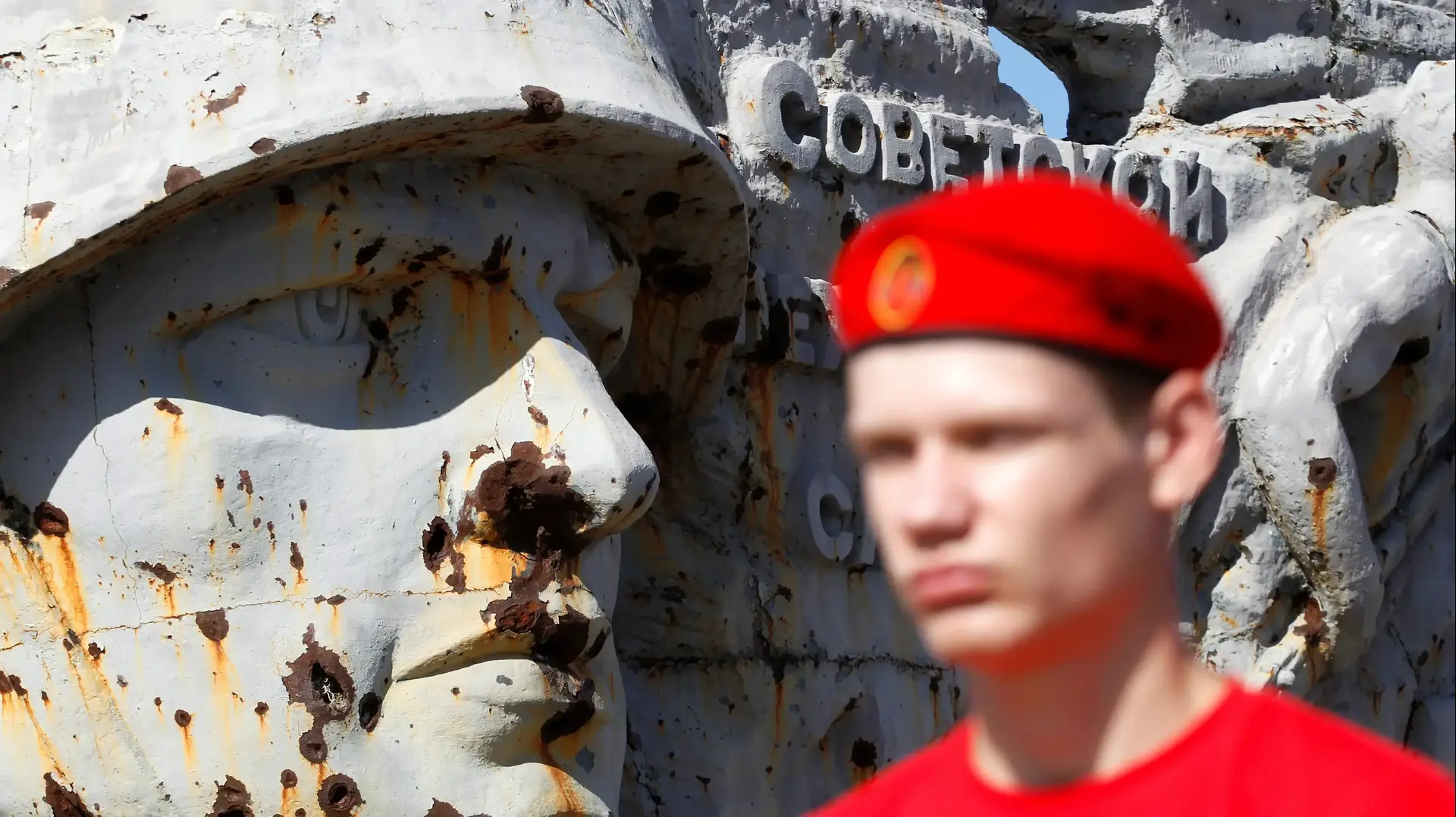 A member of youth patriotic organisation "Yunarmia" (Young army) of self-proclaimed Donetsk People's Republic (DPR) stays in front of the war memorial complex Savur-Mohyla, damaged in the recent conflict, during a ceremony marking the 77th anniversary of the liberation of the Donbas region from the Nazi occupation during World War Two, outside the rebel-held city of Donetsk, Ukraine September 8, 2020. REUTERS/Alexander Ermochenko
