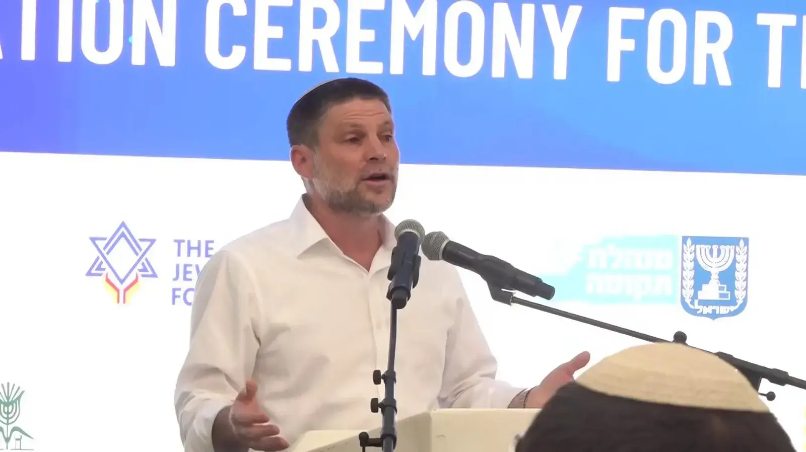 בצלאל סמוטריץ, עימות מול אייל אשל, אירוע הנחת אבן קיבוץ עין השלושה, 29 ביוני 2026 בצלאל סמוטריץ, עימות מול אייל אשל, אירוע הנחת אבן קיבוץ עין השלושה, 29 ביוני 2026
