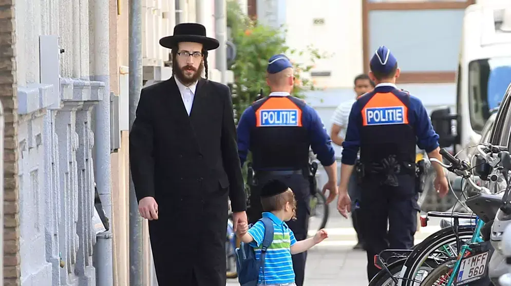 יהודי חרדי וילד עוברים שני שוטרים באנטוורפן, בלגיה, לאחר פיגוע במוזיאון יהודי בבריסל ביום שבת, מאי 25, 2014 יהודי חרדי וילד עוברים שני שוטרים באנטוורפן, בלגיה, לאחר פיגוע במוזיאון יהודי בבריסל ביום שבת, מאי 25, 2014