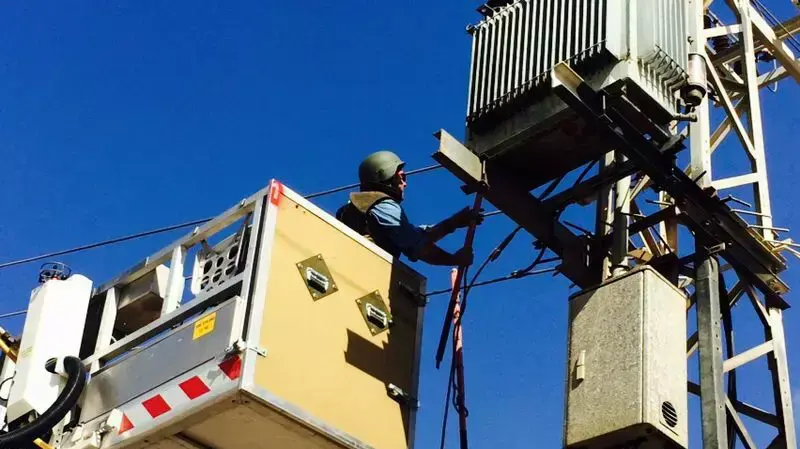 עובדי חברת החשמל מתקנים חוטים קרועים בעקבות פגיעת רקטה בעוטף עזה, יולי 2014 עובדי חברת החשמל מתקנים חוטים קרועים בעקבות פגיעת רקטה בעוטף עזה, יולי 2014